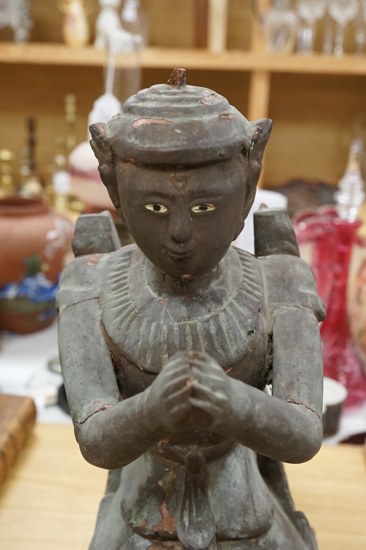 A Thai lacquered wood figure of a kneeling deity, 46cm high.
